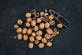 Walnuts with nutcracker over black slate stone background Royalty Free Stock Photo