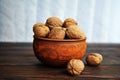 Walnuts, nuts in pottery on a wooden table. Royalty Free Stock Photo