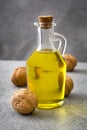 Walnuts oil on gray stone Royalty Free Stock Photo