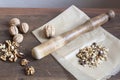 Walnuts in paper and wood battledore on a wooden background