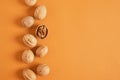 walnuts pattern on brown background, top view walnuts in shell and without shell in a row