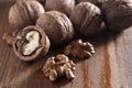 Walnuts peeled and inshell. Brown wooden background. Healthy nutrition, health care, diet. Healthy, fresh and nutritious food Royalty Free Stock Photo