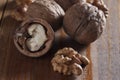 Walnuts peeled and inshell. Brown wooden table. Healthy nutrition, health care, diet. Healthy, fresh and nutritious food. Close-up Royalty Free Stock Photo