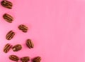 Walnuts on pink background, empty space Royalty Free Stock Photo