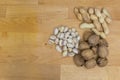 Walnuts, pistachios and peanuts on a wooden background