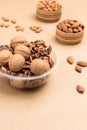 Walnuts in plastic container. Almonds in wooden box Royalty Free Stock Photo