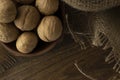 Walnuts plate on wooden table with textile. Royalty Free Stock Photo