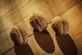 Walnuts on a rustic old wooden table. Three walnuts on a wooden table. Side view. Royalty Free Stock Photo