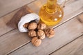 Walnuts scattered in small sacks and a bottle of squeezed oil