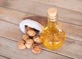 Walnuts scattered in small sacks and a bottle of squeezed oil