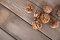 Walnuts scattered on wooden background