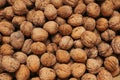 Walnuts in a shell. Background with many walnuts. Ripe walnut sold in the market