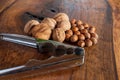 Walnuts with silver nutcracker on wooden background. It originated from a cross between English and Persian walnut trees Royalty Free Stock Photo