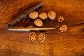 Walnuts with silver nutcracker on wooden background. It originated from a cross between English and Persian walnut trees Royalty Free Stock Photo