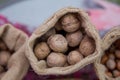 Walnuts in a small bag of containers . Close-up of walnuts as background . Mix of hazelnut with hard shell . Dried and walnuts,