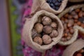 Walnuts in a small bag of containers . Close-up of walnuts as background . Mix of hazelnut with hard shell . Dried and walnuts,