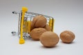 Walnuts spilling out of a small grocery cart