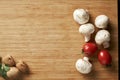 Walnuts tomatoes and mushrooms on wooden desk