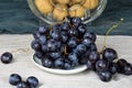 Bunches of blue grapes with walnuts behind