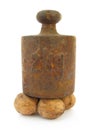 Walnuts under old iron weight