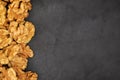 Walnuts. Walnut kernels on dark black stone background. Top view, flat lay Royalty Free Stock Photo