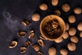 Walnuts in wooden bowl and on black slate surface. Healthy nuts and seeds composition. Royalty Free Stock Photo