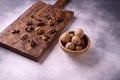 Walnuts in wooden bowl and on wooden carved board on bright textured surface. Healthy nuts and seeds composition. Royalty Free Stock Photo