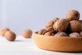 Walnuts in a wooden bowl, light background, selective focus Royalty Free Stock Photo