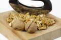 Walnuts on a wooden plate with chopping knife