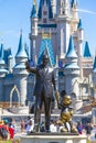 Walt Disney and Mickey mouse statue in front of Cinderella princess castle at Disney world Florida