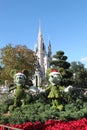 Walt Disney World Castle at Christmas with Mickey and Mnnie Topiary Plants