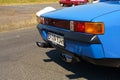 A Porsche 914. View of the trunk, taillights and exhaust pipes.