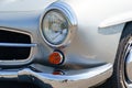 A vintage MERCEDES-BENZ 190 SL. Front view of the bumper, hood, grille and headlights.