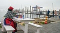 Herero woman traditional attire sitting by tourist jetty Royalty Free Stock Photo