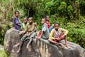 Wamena, Indonesia - January 10, 2010: People of the Dani tribe in a usual dress sitting on the big stone. Baliem Valley Papua Royalty Free Stock Photo