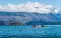 Tourist kayaking in lake Wanaka the fouth largest lake in New Zealand.