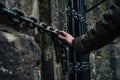 wanderer touching the castles old chain gate mechanism