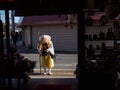 Wandering Buddhist monk blesses store, Arashiyama, Kyoto, Japan