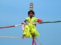 Wandering indian tightrope walker playing on the beach of Goa