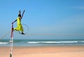 Wandering indian tightrope walker playing on the beach of Goa