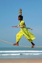 Wandering indian tightrope walker playing on the beach of Goa