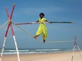 Wandering indian tightrope walker playing on the beach of Goa Royalty Free Stock Photo