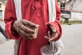 A glass of tea, in hand.  Six fingers.  Sadhu life in India Royalty Free Stock Photo