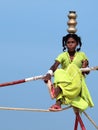 Wandering tightrope walker playing on the beach and going to walk on rope in flip flops Royalty Free Stock Photo