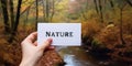 Motivational inspiring hand holding word card nature in woods