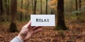 Motivational inspiring hand holding word card relax in woods Royalty Free Stock Photo