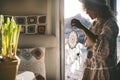 Wanderlust lifestyle people. One woman holding dreamcather decoration on the door of her mobile home with outdoors and sunset time