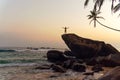 Young man on a rock in a tropical location. Getting away from it all