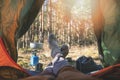 Wanderlust outdoor camping - traveler feet out of the tent