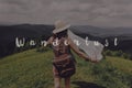 Wanderlust text sign concept, hipster traveler woman holding map